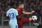 Roma's Edin Dzeko controls the ball as Barcelona's Samuel Umtiti uses both hands to restrain him during the Champions League quarterfinal second leg soccer match between between Roma and FC Barcelona, at Rome's Olympic Stadium, Tuesday, April 10, 2018. (AP Photo/Gregorio Borgia)