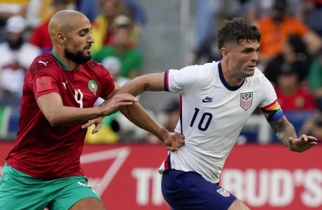 United States forward Christian Pulisic (10) dribbles past Morocco's Sofyan Amrabat (4) during the first half of a friendly soccer match, Wednesday, June 1, 2022, in Cincinnati. (AP Photo/Jeff Dean)