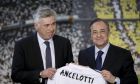 Real Madrid's new coach Carlo Ancelotti, left, and Real Madrid's President Florentino Perez display a shirt bearing the name of the new coach,  during his presentation, in Madrid, Wednesday, June 26, 2013. Real Madrid has presented new coach Carlo Ancelotti as "a true sage" of football. Ancelotti was introduced to Madrid members and the press at the Santiago Bernabeu by club president Florentino Perez on Wednesday in a step aimed at healing the rifts caused by predecessor Jose Mourinho. (AP Photo/Daniel Ochoa de Olza)