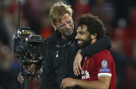 Liverpool's manager Juergen Klopp hugs Liverpool's Mohamed Salah at the end of the Champions League qualifying play-off second leg soccer match between Liverpool and Hoffenheim at Anfield stadium in Liverpool, England, Wednesday, Aug. 23, 2017. Liverpool won the match 4-2 (6-3 on aggregate). (AP Photo/Dave Thompson)