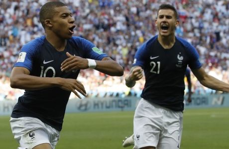 France's Kylian Mbappe, left, celebrates with team mate Lucas Hernandez after scoring his side's third goal during the round of 16 match between France and Argentina, at the 2018 soccer World Cup at the Kazan Arena in Kazan, Russia, Saturday, June 30, 2018. (AP Photo/David Vincent)