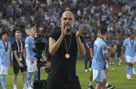 Manchester City's head coach Pep Guardiola celebrates with players after winning the UEFA Super Cup Final soccer match between Manchester City and Sevilla at Georgios Karaiskakis stadium in Piraeus port, near Athens, Greece, Wednesday, Aug. 16, 2023. (AP Photo/Petros Giannakouris)