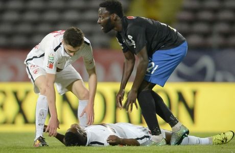 Dinamo's Patrick Ekeng of Cameroon lies on the pitch after collapsing during a league game in Bucharest, Romania, Friday, May 6, 2016. Dinamo Bucharest player Patrick Ekeng died after he collapsed during a match in the Romanian capital on Friday, doctors said. He was 26. (AP Photo) ROMANIA OUT
