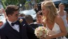 epa05436715 German international soccer player Mario Gomez (L) and his bride Carina arrive for their civil marriage at the registry office Schwabing in Munich, Germany, 22 July 2016. EPA/SVEN HOPPE