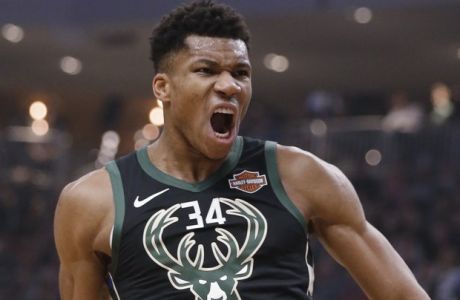Milwaukee Bucks' Giannis Antetokounmpo reacts after he dunked against the Phoenix Suns during the first half of an NBA basketball game Friday, Nov. 23, 2018, in Milwaukee. (AP Photo/Jeffrey Phelps)