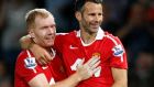 FILE - This is a Monday, Aug. 16, 2010 file photo Manchester United's Ryan Giggs, right,  with teammate Paul Scholes after scoring a goal against Newcastle United during their English Premier League soccer match at Old Trafford, Manchester, England.  Ryan Giggs will be assisted by former teammates Paul Scholes, Nicky Butt and Phil Neville during his spell as interim manager of Manchester United following the dismissal of David Moyes. (AP Photo/Tim Hales, File)