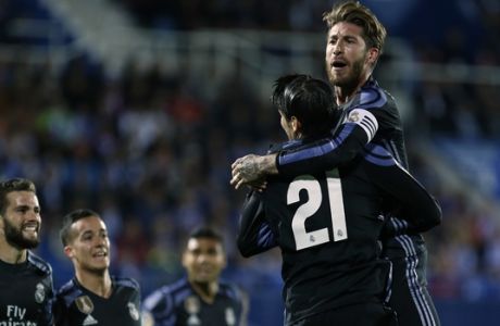 Real Madrid's Alvaro Morata, second right, celebrates with teammates Sergio Ramos, top, Jose Luis Fernandez "Nacho", left, and Lucas Vazquez, second left, their side's second goal against Leganes during a Spanish La Liga soccer match between Leganes and Real Madrid at the Butarque stadium in Madrid, Wednesday, April 5, 2017. (AP Photo/Francisco Seco)