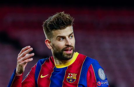 Barcelona's Gerard Pique reacts during the Champions League round of 16, first leg soccer match between FC Barcelona and Paris Saint-Germain at the Camp Nou stadium in Barcelona, Spain, Tuesday, Feb. 16, 2021. (AP Photo/Joan Monfort)