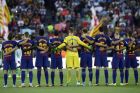 Barcelona players stand for a minute of silence for the victims of the van attacks before a La Liga soccer match between Barcelona and Betis at the Camp Nou stadium in Barcelona, Spain, Sunday, Aug. 20, 2017. Security was stepped up for the match after a terror attack that killed 14 people and wounded over 120 in Barcelona and police put up scores of roadblocks across northeast Spain on Sunday in hopes of capturing a fugitive suspect at large following the vehicle attack. Barcelona players are all wearing shirts with 'Barcelona' on their backs tonight, rather than their names to pay homage to the van attack victims. (AP Photo/Manu Fernandez)