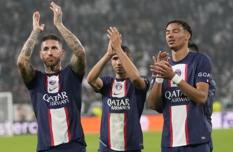 PSG's Sergio Ramos, left, PSG's Hugo Ekitike, right, and PSG's Achraf Hakimi applaud fans at the end of the Champions League group H soccer match between Juventus and Paris Saint Germain at the Allianz stadium in Turin, Italy, Wednesday, Nov. 2, 2022. (AP Photo/Antonio Calanni)