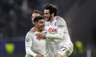 Napoli's Giovanni Di Lorenzo, left, celebrates with Napoli's Khvicha Kvaratskhelia after scoring his side's second goal during the Champions League round of 16 second leg soccer match between Eintracht Frankfurt and Napoli, at the Deutsche Bank Arena in Frankfurt, Germany, Tuesday, Feb. 21, 2023. (AP Photo/Michael Probst)