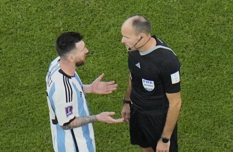 Argentina's Lionel Messi, left, argues with referee Mateu Lahoz during the World Cup quarterfinal soccer match between the Netherlands and Argentina, at the Lusail Stadium in Lusail, Qatar, Friday, Dec. 9, 2022. (AP Photo/Hassan Ammar)