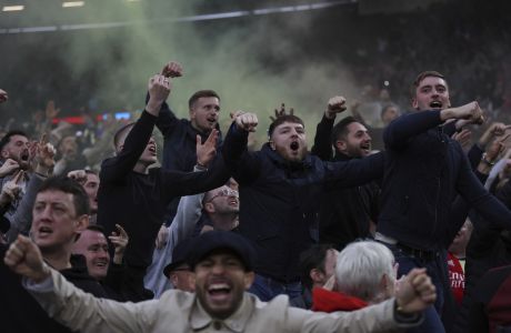 Arsenal fans celebrate after Arsenal's Rob Holding scores the opening goal of the game during the English Premier League soccer match between West Ham United and Arsenal at the London stadium in London, Sunday, May 1, 2022. (AP Photo/Ian Walton)