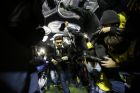 FILE- In this May 15, 2015, file photo, Marcelo Gallardo coach of River Plate, center, leaves the field protected by riot police after the match against Boca Juniors was suspended during a Copa Libertadores soccer match in Buenos Aires, Argentina.  Conmebol authorities and referee Dario Herrera canceled the game after pepper spray was thrown from the stands towards River Plate players, before the start of the second half of the game. (AP Photo/Victor R. Caivano, File)