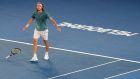 Greece's Stefanos Tsitsipas celebrates after defeating Switzerland's Roger Federer in their fourth round match at the Australian Open tennis championships in Melbourne, Australia, Sunday, Jan. 20, 2019. (AP Photo/Aaron Favila)