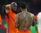 Netherlands' Memphis Depay shows his lion tattoo after losing the international friendly soccer match between The Netherlands and Italy at the Amsterdam ArenA stadium, Netherlands, Tuesday, March 28, 2017. The Netherlands were defeated by Italy with 1-2. (AP Photo/Peter Dejong)