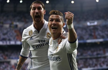 Real Madrid's Cristiano Ronaldo celebrates with Real Madrid's Sergio Ramos after scoring the opening goal during the Champions League semifinals first leg soccer match between Real Madrid and Atletico Madrid at Santiago Bernabeu stadium in Madrid, Spain, Tuesday May 2, 2017. (AP Photo/Daniel Ochoa de Olza)
