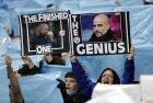Manchester City supporters hold up pictures of Manchester United manager Jose Mourinho, left, and Manchester City coach Pep Guardiola, right, before the English Premier League soccer match between Manchester City and Manchester United at the Etihad Stadium in Manchester, England, Saturday April 7, 2018. (AP Photo/Matt Dunham)