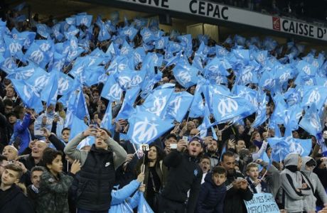 Marseille supporters wave flags during the League One soccer match between Marseille and Paris Saint-Germain, at the Velodrome Stadium, in Marseille, southern France, Sunday, Feb. 26, 2017. (AP Photo/Claude Paris)