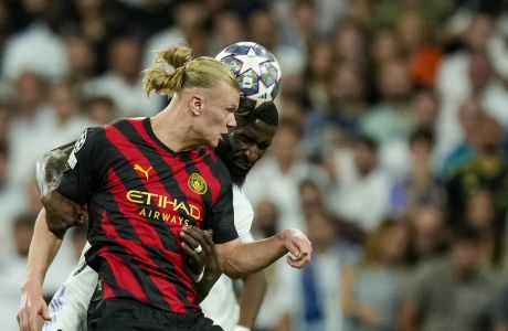 Manchester City's Erling Haaland, front, duels for the ball with Real Madrid's Antonio Rudiger during the Champions League semifinal first leg soccer match between Real Madrid and Manchester City at the Santiago Bernabeu stadium in Madrid, Spain, Tuesday, May 9, 2023. (AP Photo/Jose Breton)
