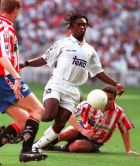 Real Madrid's Dutch international Clarence Seedorf nips between two unidentified Sporting players during a league match in Madrid Sunday May 4, 1997. Real Madrid came from a goal behind to win the game 3-1. (AP Photo/Paul White)
