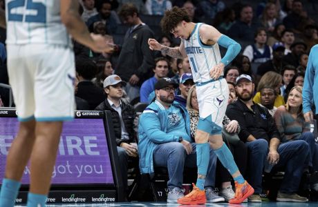 Charlotte Hornets guard LaMelo Ball reacts after being shaken up on a play during the second half of the tema's NBA basketball game against the Indiana Pacers in Charlotte, N.C., Wednesday, Nov. 16, 2022. (AP Photo/Jacob Kupferman)