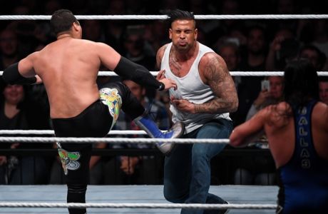 In this Nov. 3, 2016 photo former soccer player Tim Wiese aka. 'The Machine', center, performs at the Wrestling event at the Olympiahalle in Munich, Germany. , at his wrestling debut during and event of World Wrestling Entertainment (WWE) in Munich. (Sven Hoppe/dpa via AP)