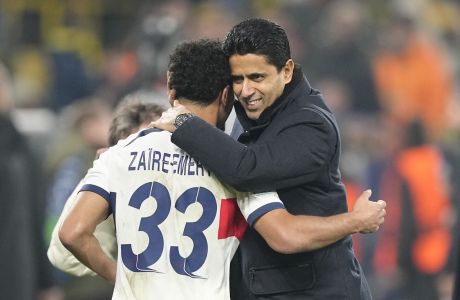 PSG president Nasser Al-Khelaifi, right, and PSG's Warren Zaire-Emery hug after the Champions League Group F soccer match between Borussia Dortmund and Paris Saint-Germain at the Signal Iduna Park in Dortmund, Germany, Wednesday, Dec. 13, 2023. (AP Photo/Martin Meissner)