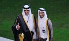 Emir of Qatar Tamim bin Hamad Al Thani, left, gives thumbs up as he stands with his older brother Sheikh Jassim bin Hamad Al Thani on the podium after the World Cup final soccer match between Argentina and France at the Lusail Stadium in Lusail, Qatar, Sunday, Dec. 18, 2022. (AP Photo/Hassan Ammar)