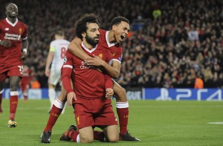 Liverpool's Mohamed Salah, front left, celebrates with Trent Alexander-Arnold after scoring his side's seventh goal during the Champions League Group E soccer match between Liverpool and Spartak Moscow at Anfield, Liverpool, England, Wednesday, Dec. 6, 2017. (AP Photo/Rui Vieira)