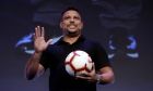 FILE - Former Brazilian soccer star Ronaldo Luis Nazario waves to the crowd before a World Football Summit conference, in Madrid, Spain, Sept. 25, 2018. Less than year after Ronaldo got involved with the Cruzeiro club, it has made it back into the country's top soccer league. The Brazilian team clinched a top-four spot in the second division on Wednesday, Sept. 21, 2022. (AP Photo/Manu Fernandez, File)
