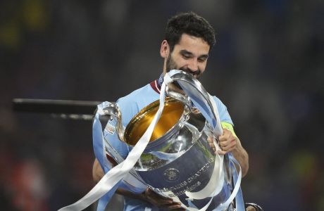 Manchester City's Ilkay Gundogan holds the trophy after the Champions League final soccer match between Manchester City and Inter Milan at the Ataturk Olympic Stadium in Istanbul, Turkey, Sunday, June 11, 2023. (AP Photo/Emrah Gurel)