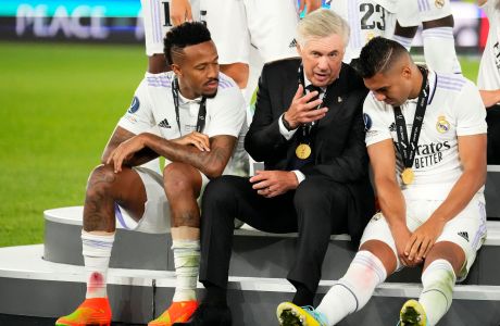 Real Madrid's head coach Carlo Ancelotti, center, speaks with Eder Militao, left, and Casemiro after winning the UEFA Super Cup final soccer match between Real Madrid and Eintracht Frankfurt at Helsinki's Olympic Stadium, Finland, Wednesday, Aug. 10, 2022. (AP Photo/Sergei Grits)