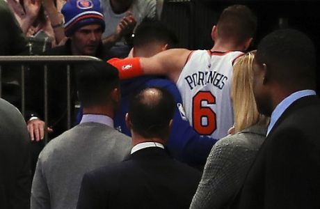 New York Knicks forward Kristaps Porzingis (6) is helped off the court after turning an ankle against the Miami Heat during the first quarter of an NBA basketball game, Wednesday, Nov. 29, 2017, in New York. (AP Photo/Julie Jacobson)