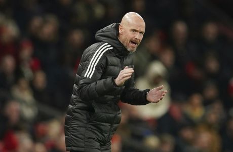 Manchester United's head coach Erik ten Hag gestures to his players during the English League Cup 4th round soccer match between Manchester United and Burnley, at Old Trafford in Manchester, England Wednesday, Dec. 21, 2022. (AP Photo/Dave Thompson)