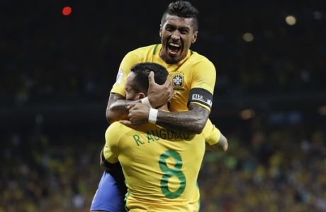 Paulinho, top, celebrates scoring his side's third goal against Argentina with teammate Renato Augusto during a 2018 World Cup qualifying soccer match at the Mineirao stadium in Belo Horizonte, Brazil, Thursday Nov. 10, 2016.(AP Photo/Andre Penner)