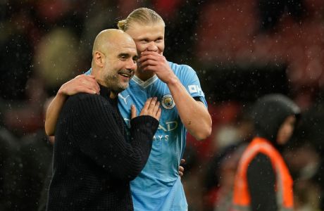 Manchester City's head coach Pep Guardiola talks to Manchester City's Erling Haaland after the English Premier League soccer match between Manchester United and Manchester City at Old Trafford stadium in Manchester, England, Sunday, Oct. 29, 2023. (AP Photo/Dave Thompson)
