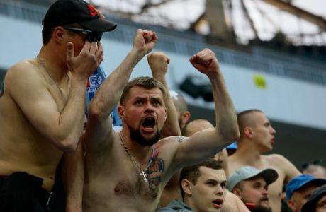 In this photo taken on Saturday, April 21, 2018, Russian soccer fans cheer during the Russian league soccer match between Rotor and Luch-Energiya at the new the World Cup stadium in Volgograd, Russia . The stadium will hold group-stage games at the World Cup. (AP Photo/Dmitriy Rogulin)