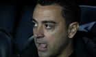 Barcelona's head coach Xavi Hernandez concentrates prior the start of the Spanish Copa del Rey semi final, second leg soccer match between Barcelona and Real Madrid at the Camp Nou stadium in Barcelona, Spain, Wednesday, April 5, 2023. (AP Photo/Joan Mateu Parra)