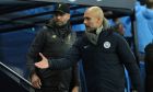 Liverpool's manager Jurgen Klopp, left with Manchester City's manager Pep Guardiola arrive in the technical area prior to the start of the English Premier League soccer match between Manchester City and Liverpool at the Ethiad stadium, Manchester England, Thursday, Jan. 3, 2019. (AP Photo/Jon Super)