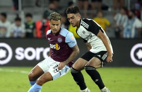 Aston Villa's Philippe Coutinho (23) advances the ball past Fulham's Matthew Dibley-Dias, right, during the second half of a Premier League Summer Series soccer match Wednesday, July 26, 2023, in Orlando, Fla. (AP Photo/John Raoux)