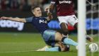 Tottenham Hotspur's Juan Foyth, left, goes to block West Ham United's Michail Antonio shooting at goal during the English League Cup 4th round soccer match between West Ham United and Tottenham Hotspur at the London stadium in London, Wednesday, Oct. 31, 2018. (AP Photo/Alastair Grant)