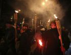 Activists carry torches and flares during a rally dedicated to the fifth anniversary of the dispersal of the wave of demonstrations and civil unrest known as  Euromaidan, in Kiev, Ukraine, Thursday, Nov. 29, 2018. Protesters demanded the results of the investigation of crimes committed during the Euromaidan in 2013-14. (AP Photo/Serhii Nuzhnenko)
