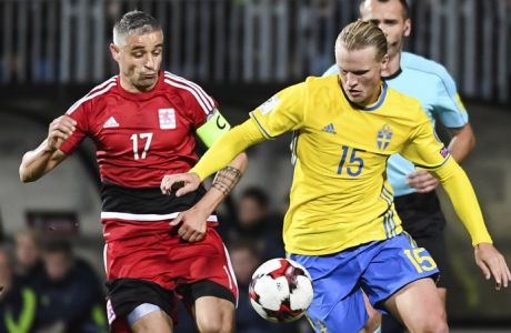 Luxembourg's Mario Mutsch, left, challenges Sweden's Oscar Hiljemark during their World Cup Group A qualifying soccer match at the Josy Barthel stadium in Luxembourg on Friday, Oct. 7, 2016. (AP Photo/Geert Vanden Wijngaert)