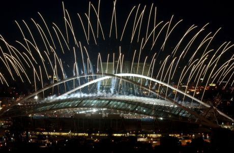 Fireworks are seen on the sky above the Athens Olympic stadium during the opening ceremony of Athens 2004 Olympic games Friday, Aug. 13, 2004. (AP Photo/Petros Giannakouris)