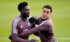 Bayern's Alphonso Davies, left, and Bayern's Jamal Musiala, right, attend a training session in Munich, Germany, Tuesday, March 7, 2023 prior to the Champions League group round of 16 second leg soccer match between Bayern Munich and Paris Saint Germain. Bayern will face PSG on Wednesday, March 8, 2023. (AP Photo/Matthias Schrader)