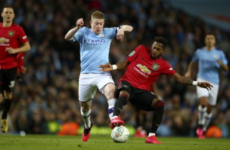 Manchester City's Kevin De Bruyne, center left, vies for the ball with Manchester United's Fred during the English League Cup semifinal second leg soccer match between Manchester City and Manchester United at Etihad stadium in Manchester, England, Wednesday, Jan. 29, 2020. (AP Photo/Dave Thompson)