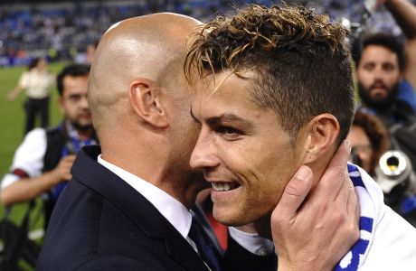 Real Madrid's Cristiano Ronaldo celebrates with Real Madrid's head coach Zinedine Zidane after winning a Spanish La Liga soccer match between Malaga and Real Madrid in Malaga, Spain, Sunday, May 21, 2017. Real Madrid wins the Spanish league for the first time in five years, avoiding its biggest title drought since the 1980s. (AP Photo/Daniel Tejedor)