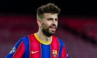 Barcelona's Gerard Pique looks on during the Champions League round of 16, first leg soccer match between FC Barcelona and Paris Saint-Germain at the Camp Nou stadium in Barcelona, Spain, Tuesday, Feb. 16, 2021. (AP Photo/Joan Monfort)