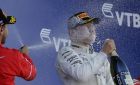 Ferrari driver Sebastian Vettel of Germany, left, sprays champagne on Mercedes driver Valtteri Bottas of Finland on the podium of the Formula One Russian Grand Prix at the 'Sochi Autodrom' circuit, in Sochi, Russia, Sunday, April. 30, 2017. Bottas won the race and Vettel was secod. (AP Photo/Sergei Grits)